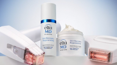 EltaMD Skin Recovery Regenerating Rapid Recovery Serum bottle and open Rapid Recovery Cream jar, both labeled “EGF Tripeptide Technology,” displayed between two white aesthetic treatment devices against a light blue background.