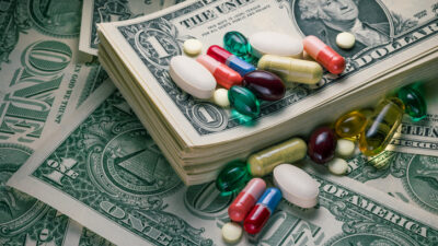 close-up studio macro shot of various pills on US dollar bills.